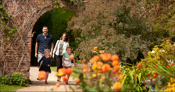 Family walking through the walled garden at Raby Castle